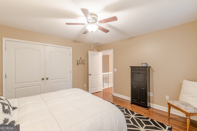 5767 Wembley Dr, Douglasville, GA 30135 - bedroom featuring wood finished floors, a closet, and ceiling fan