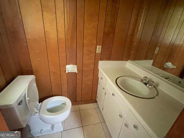 404 S Baker St, Glennville, GA 30427 - half bath with wood walls, vanity, and tile patterned floors