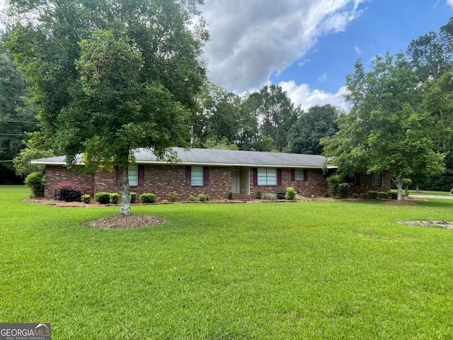 404 S Baker St, Glennville, GA 30427 - ranch-style house with a front lawn, brick siding, and view of wooded area