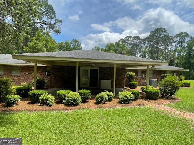 404 S Baker St, Glennville, GA 30427 - ranch-style house with a front yard, brick siding, central AC unit, and a chimney