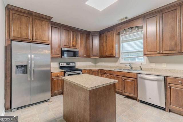 2378 Randall Ave, Lithonia, GA 30058 - kitchen featuring stainless steel appliances, a sink, a center island, and light countertops