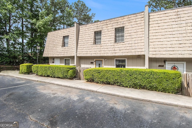6433 Stone Ter, Morrow, GA 30260 - view of property featuring mansard roof and uncovered parking