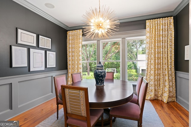 50 Frederica Oaks Ln, Saint Simons, GA 31522 - dining room with a chandelier, ornamental molding, plenty of natural light, wood finished floors, and a decorative wall