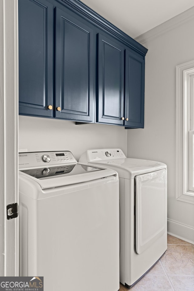 50 Frederica Oaks Ln, Saint Simons, GA 31522 - laundry room with washer and dryer, cabinet space, light tile patterned flooring, and baseboards