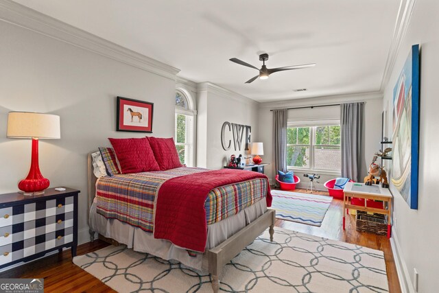 50 Frederica Oaks Ln, Saint Simons, GA 31522 - bedroom with wood finished floors, ornamental molding, baseboards, and ceiling fan