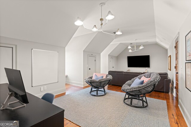 50 Frederica Oaks Ln, Saint Simons, GA 31522 - home theater featuring lofted ceiling, wood finished floors, a chandelier, and baseboards