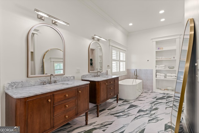 50 Frederica Oaks Ln, Saint Simons, GA 31522 - bathroom with two vanities, ornamental molding, a soaking tub, healthy amount of natural light, and a wainscoted wall