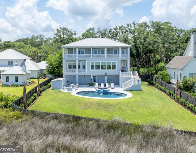 50 Frederica Oaks Ln, Saint Simons, GA 31522 - back of property featuring a balcony, stairs, a patio area, a pool with connected hot tub, and metal roof