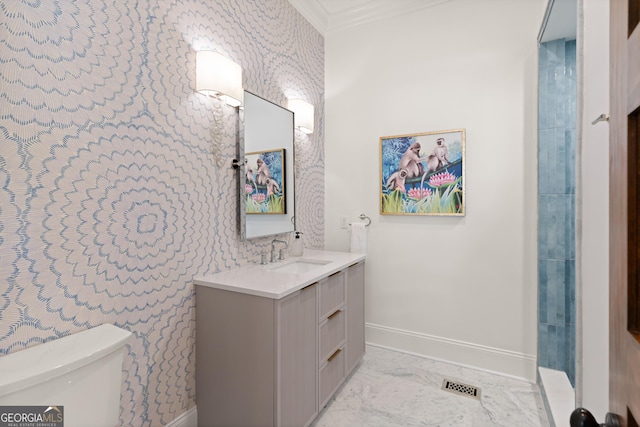 50 Frederica Oaks Ln, Saint Simons, GA 31522 - bathroom with wallpapered walls, baseboards, toilet, vanity, and marble finish floors