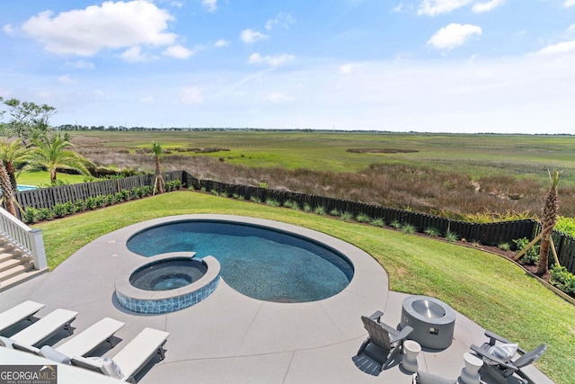 50 Frederica Oaks Ln, Saint Simons, GA 31522 - view of swimming pool featuring a pool with connected hot tub, a rural view, and a patio area