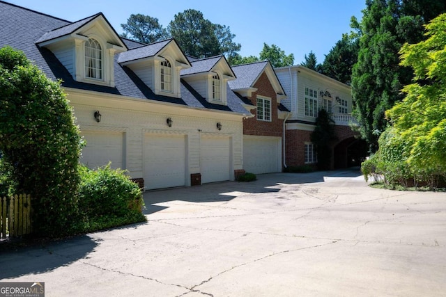 4790 Shallowford Rd, Roswell, GA 30075 - view of front of property with concrete driveway, brick siding, a garage, and roof with shingles
