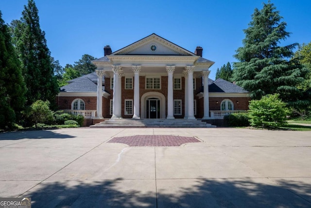 4790 Shallowford Rd, Roswell, GA 30075 - view of front of home with covered porch, a chimney, and brick siding