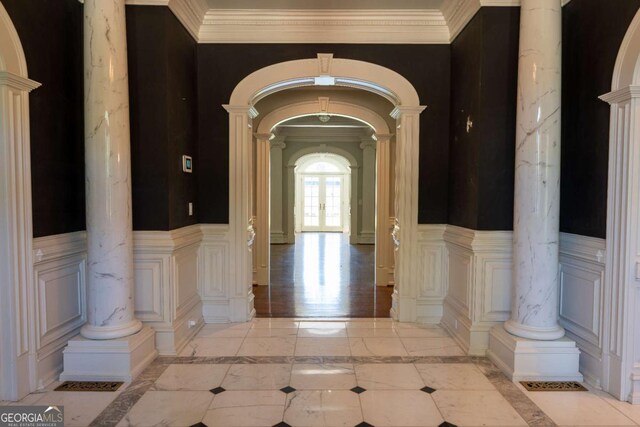 4790 Shallowford Rd, Roswell, GA 30075 - corridor featuring arched walkways, decorative columns, a decorative wall, inlaid floor details, and wainscoting