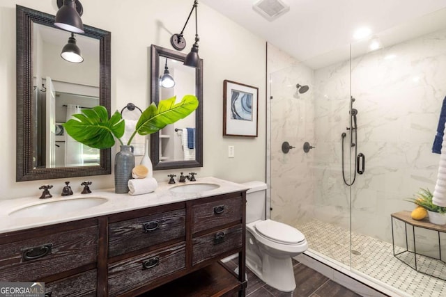 1002 Forrest Blvd, Decatur, GA 30030 - bathroom featuring a marble finish shower, double vanity, wood finished floors, toilet, and baseboard heating