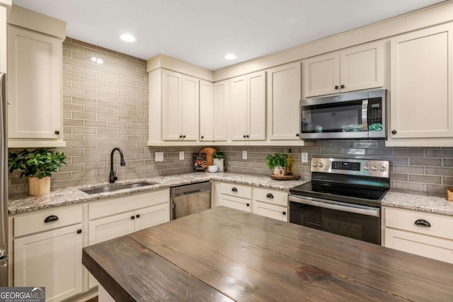 1002 Forrest Blvd, Decatur, GA 30030 - kitchen with appliances with stainless steel finishes, wooden counters, a sink, backsplash, and recessed lighting