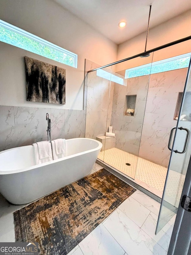 1463 Macklone St NE, Atlanta, GA 30307 - bathroom with marble look tiles, healthy amount of natural light, a marble finish shower, tile walls, and a soaking tub