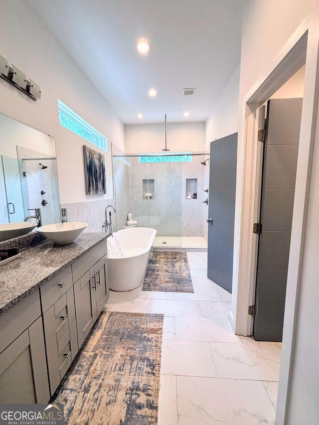1463 Macklone St NE, Atlanta, GA 30307 - full bath featuring a walk in shower, vanity, marble look tiles, a freestanding bath, and tile walls