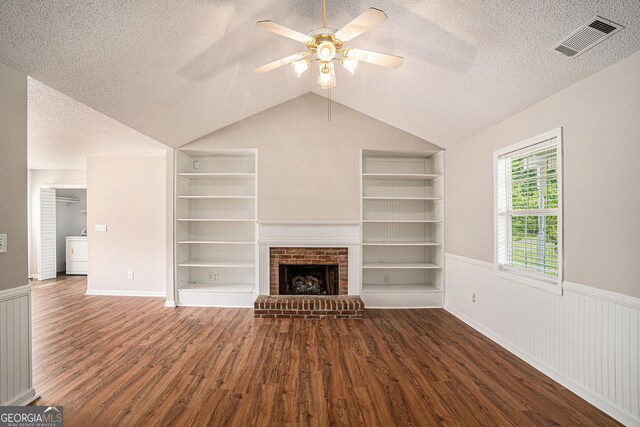 75 Plantation Ln, Locust Grove, GA 30248 - unfurnished living room featuring washer / dryer, a textured ceiling, built in shelves, wood finished floors, and ceiling fan