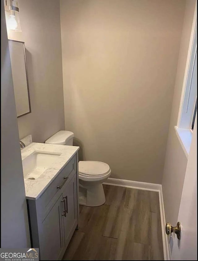 2058 Pair Rd SW, Marietta, GA 30008 - half bath with vanity, wood finished floors, toilet, and baseboards