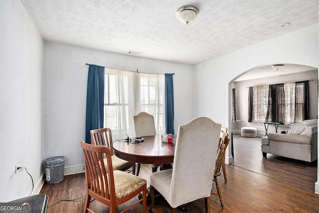 119 Pearl St, Rockmart, GA 30153 - dining space featuring arched walkways, wood finished floors, and a textured ceiling
