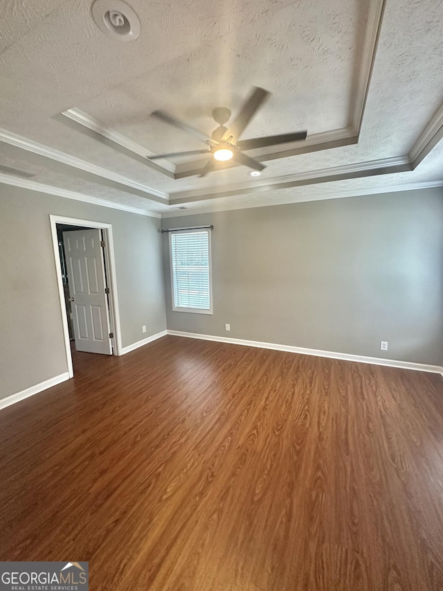 80 Fields Creek Way, Covington, GA 30016 - empty room featuring a textured ceiling, a tray ceiling, crown molding, dark wood-style flooring, and ceiling fan