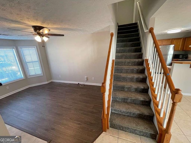 3251 Avensong Village Cir, Milton, GA 30004 - staircase with ceiling fan, wood finished floors, and a textured ceiling