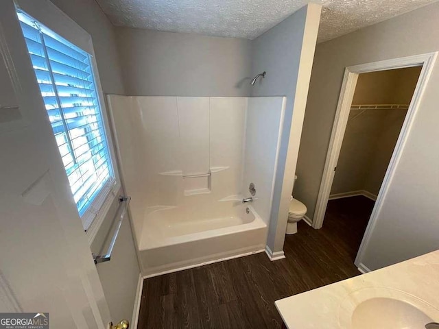 3251 Avensong Village Cir, Milton, GA 30004 - full bathroom with wood finished floors, vanity, shower / bath combination, a textured ceiling, and a spacious closet