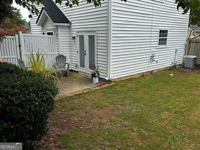 3251 Avensong Village Cir, Milton, GA 30004 - rear view of property featuring central AC, a patio, and roof with shingles