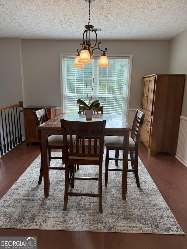 60 Buck Trl, Newnan, GA 30265 - dining area featuring wood finished floors, a textured ceiling, and a chandelier