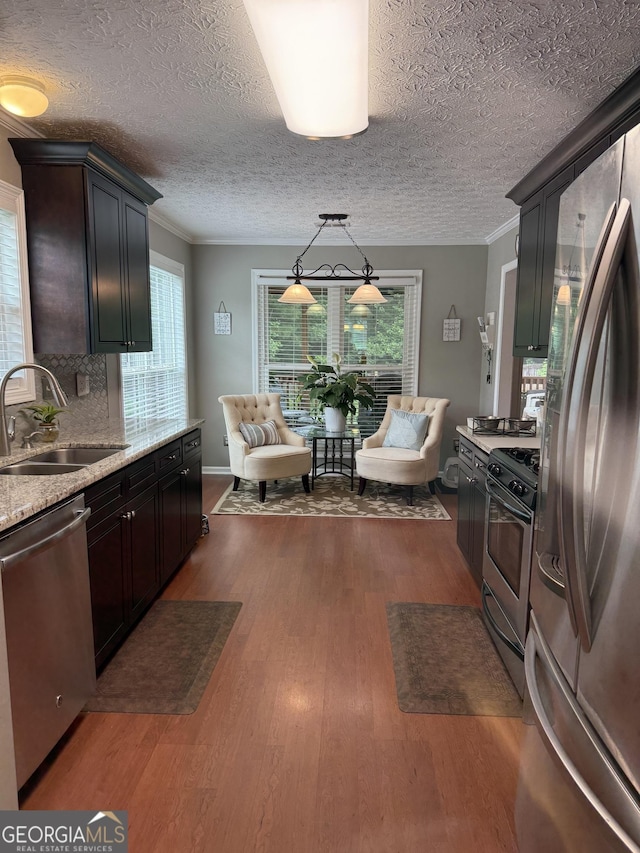 60 Buck Trl, Newnan, GA 30265 - kitchen featuring stainless steel appliances, a sink, dark wood-type flooring, healthy amount of natural light, and ornamental molding