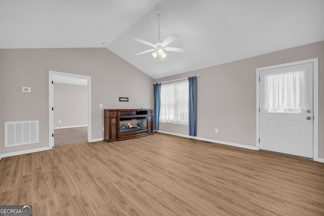 1861 Skyline Dr, Toccoa, GA 30577 - unfurnished living room featuring ceiling fan, light wood-style floors, vaulted ceiling, and baseboards