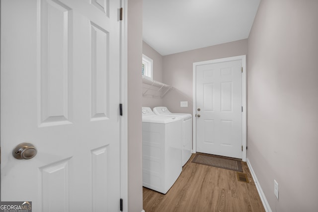1861 Skyline Dr, Toccoa, GA 30577 - laundry room featuring independent washer and dryer, light wood-type flooring, and baseboards