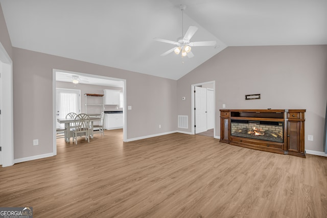 1861 Skyline Dr, Toccoa, GA 30577 - unfurnished living room with ceiling fan, light wood-style flooring, high vaulted ceiling, and baseboards