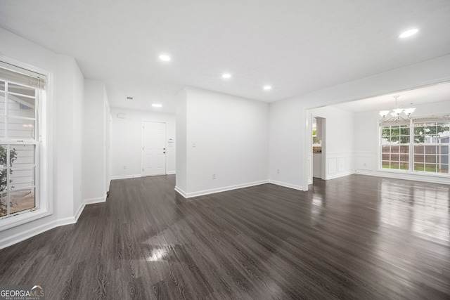 773 Minor Oaks Run NW, Lilburn, GA 30047 - unfurnished living room with a chandelier, dark wood-type flooring, and recessed lighting