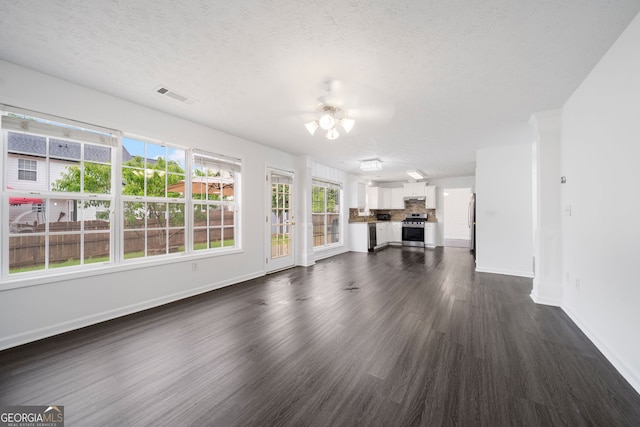773 Minor Oaks Run NW, Lilburn, GA 30047 - unfurnished living room featuring ceiling fan, dark wood-style flooring, and a textured ceiling