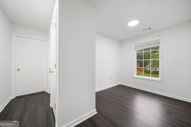 773 Minor Oaks Run NW, Lilburn, GA 30047 - unfurnished room with dark wood-style floors and baseboards