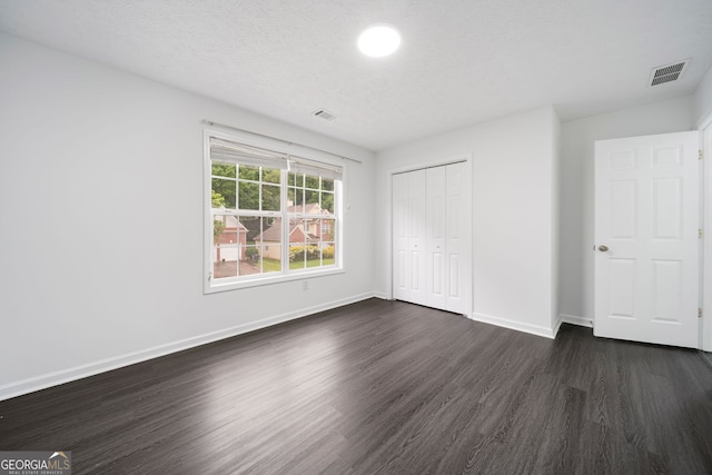 773 Minor Oaks Run NW, Lilburn, GA 30047 - unfurnished bedroom featuring dark wood-type flooring and a closet