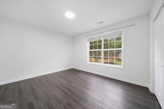773 Minor Oaks Run NW, Lilburn, GA 30047 - unfurnished bedroom with dark wood-type flooring and a closet