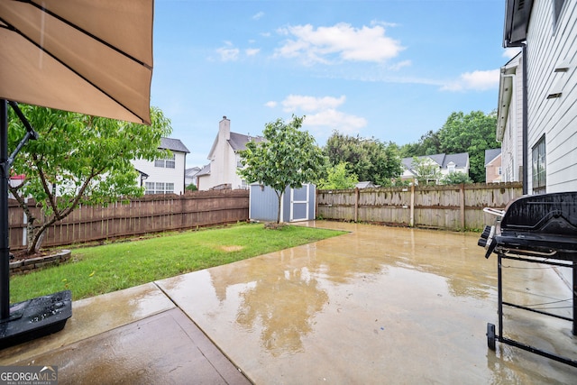 773 Minor Oaks Run NW, Lilburn, GA 30047 - fenced backyard featuring a storage unit, a patio, a grill, and a residential view