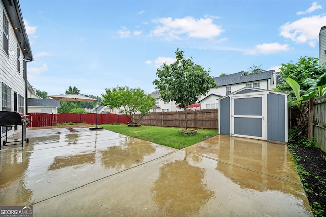 773 Minor Oaks Run NW, Lilburn, GA 30047 - fenced backyard featuring a patio, a storage shed, and area for grilling