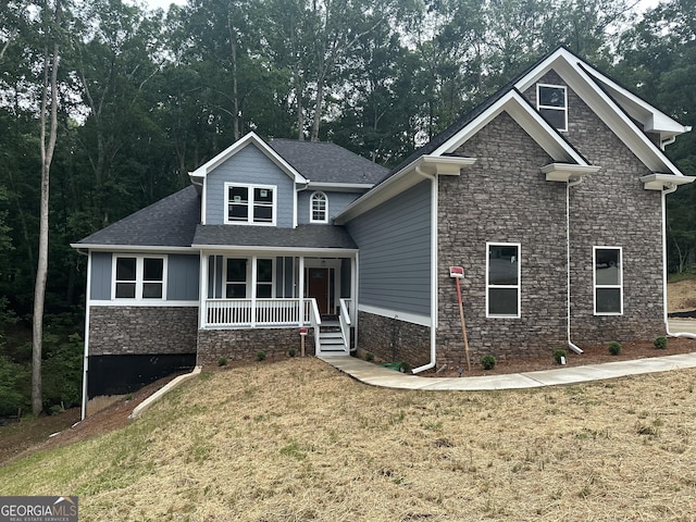 1119 Plantation Dr SE, Conyers, GA 30094 - craftsman house featuring stone siding, a porch, and a front yard