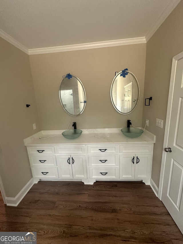 1119 Plantation Dr SE, Conyers, GA 30094 - bathroom featuring crown molding, double vanity, and wood finished floors