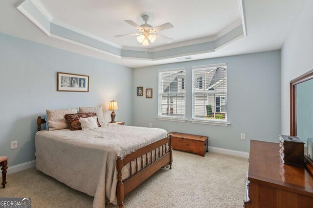 2565 Grapevine Cir Unit 103, Cumming, GA 30041 - carpeted bedroom featuring a raised ceiling, crown molding, and a ceiling fan