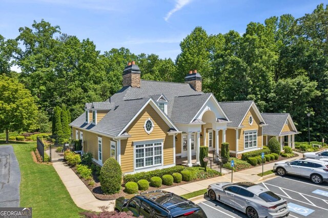 2565 Grapevine Cir Unit 103, Cumming, GA 30041 - view of front facade featuring uncovered parking and a chimney