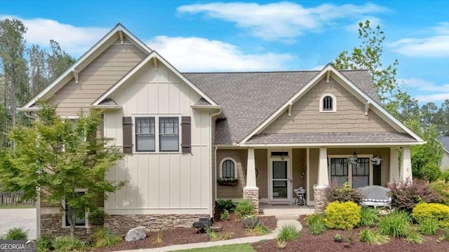 60 Independence Ave, Dallas, GA 30132 - craftsman-style house featuring board and batten siding, a porch, roof with shingles, and stone siding