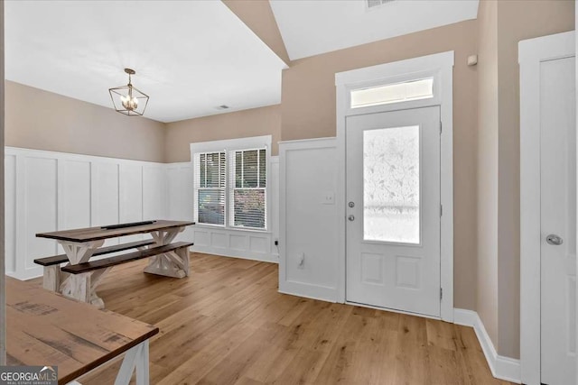 60 Independence Ave, Dallas, GA 30132 - entryway featuring a decorative wall, light wood-type flooring, a wainscoted wall, and a chandelier