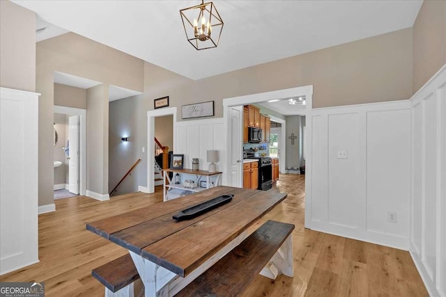 60 Independence Ave, Dallas, GA 30132 - dining room with stairway, light wood-type flooring, a chandelier, and a decorative wall
