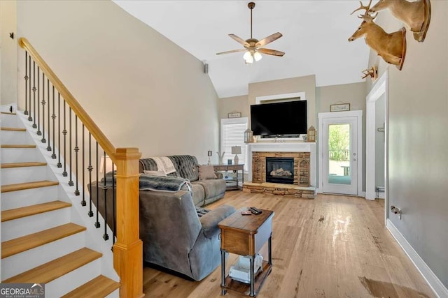 60 Independence Ave, Dallas, GA 30132 - living area featuring a ceiling fan, light wood-style flooring, stairway, high vaulted ceiling, and a stone fireplace
