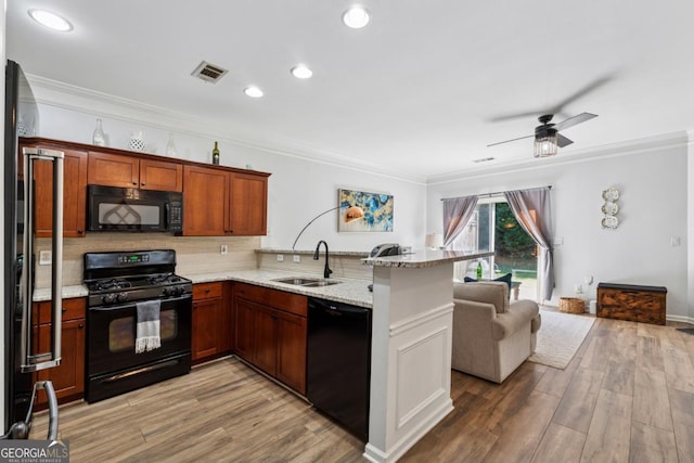 771 Arbor Gate Ln, Lawrenceville, GA 30044 - kitchen with black appliances, a sink, crown molding, tasteful backsplash, and a peninsula