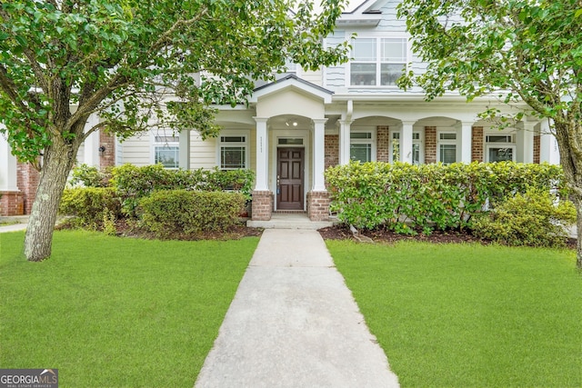 111 Moonlight Trl, Port Wentworth, GA 31407 - view of front of property with brick siding, a front lawn, and a porch